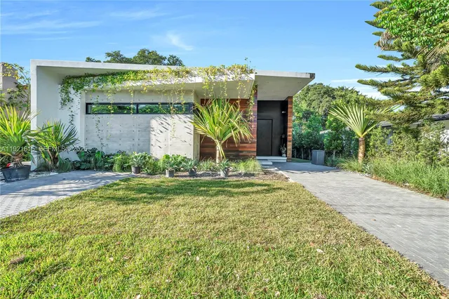 a bedroom with furniture and a large window