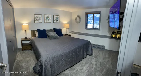 a bedroom with a bed and window