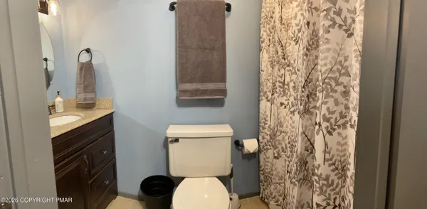 a white toilet sitting next to a bathroom sink