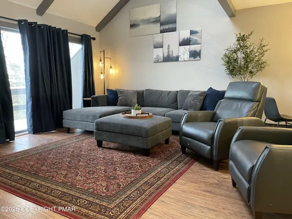 a living room with furniture and a rug