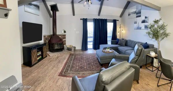 a living room with furniture and a flat screen tv