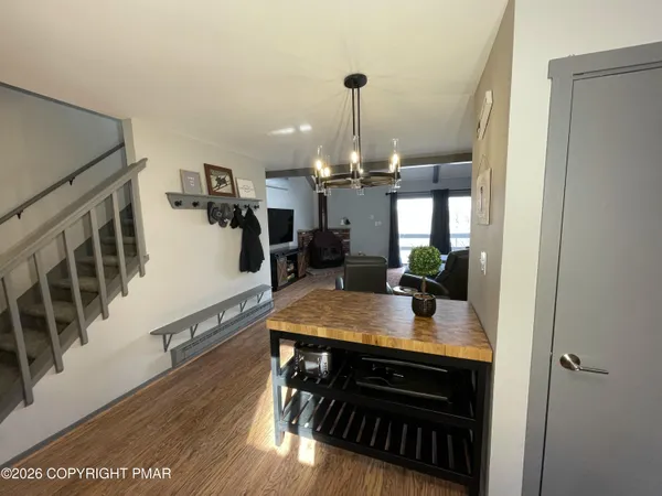 a kitchen with kitchen island a stove and a wooden floor
