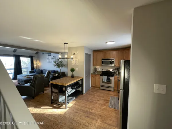 a living room with furniture and kitchen view