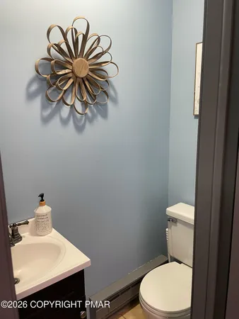 a bathroom with a toilet a sink and mirror