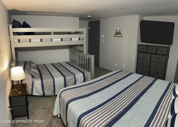 a bedroom with bed and wooden floor