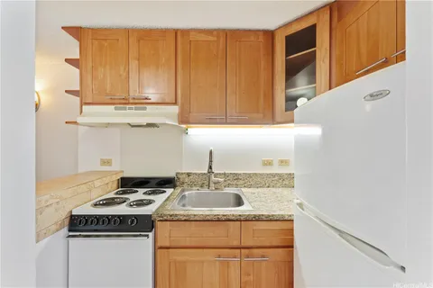 a kitchen with a stove and a refrigerator