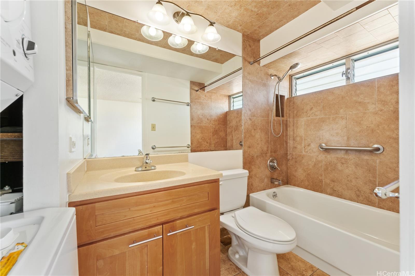 2525 Date Street, Unit 2704 Honolulu, HI 96826 - Photo 8 of 12 a bathroom with a sink a toilet and a bathtub