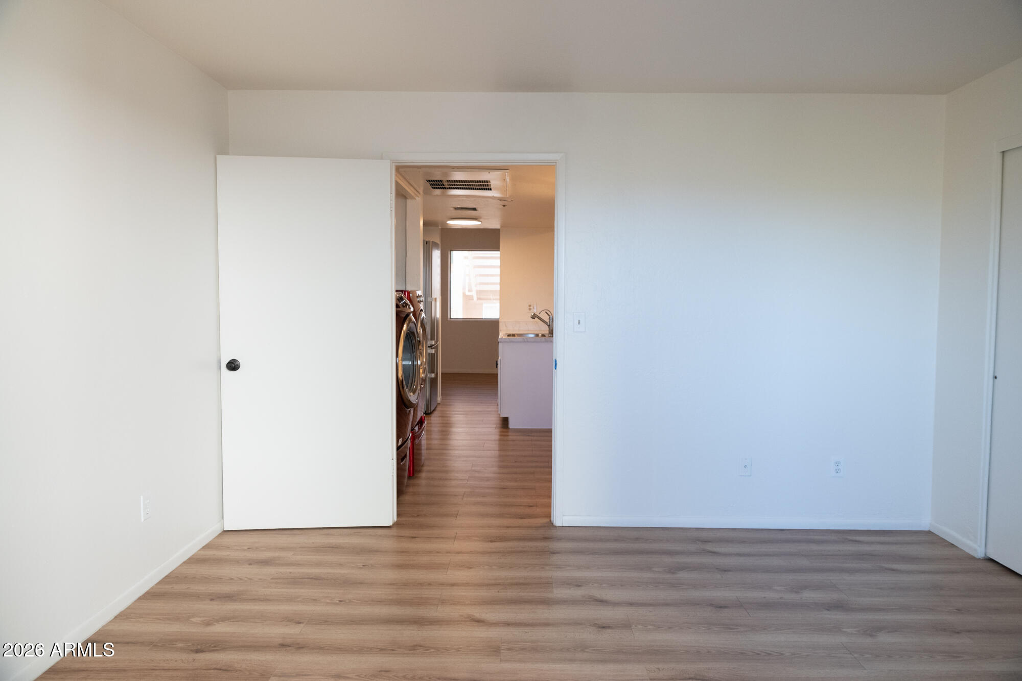 12123 West Bell Road, Unit 219 Surprise, AZ 85378 - Photo 12 of 23 a view of a hallway with wooden floor and a bathroom
