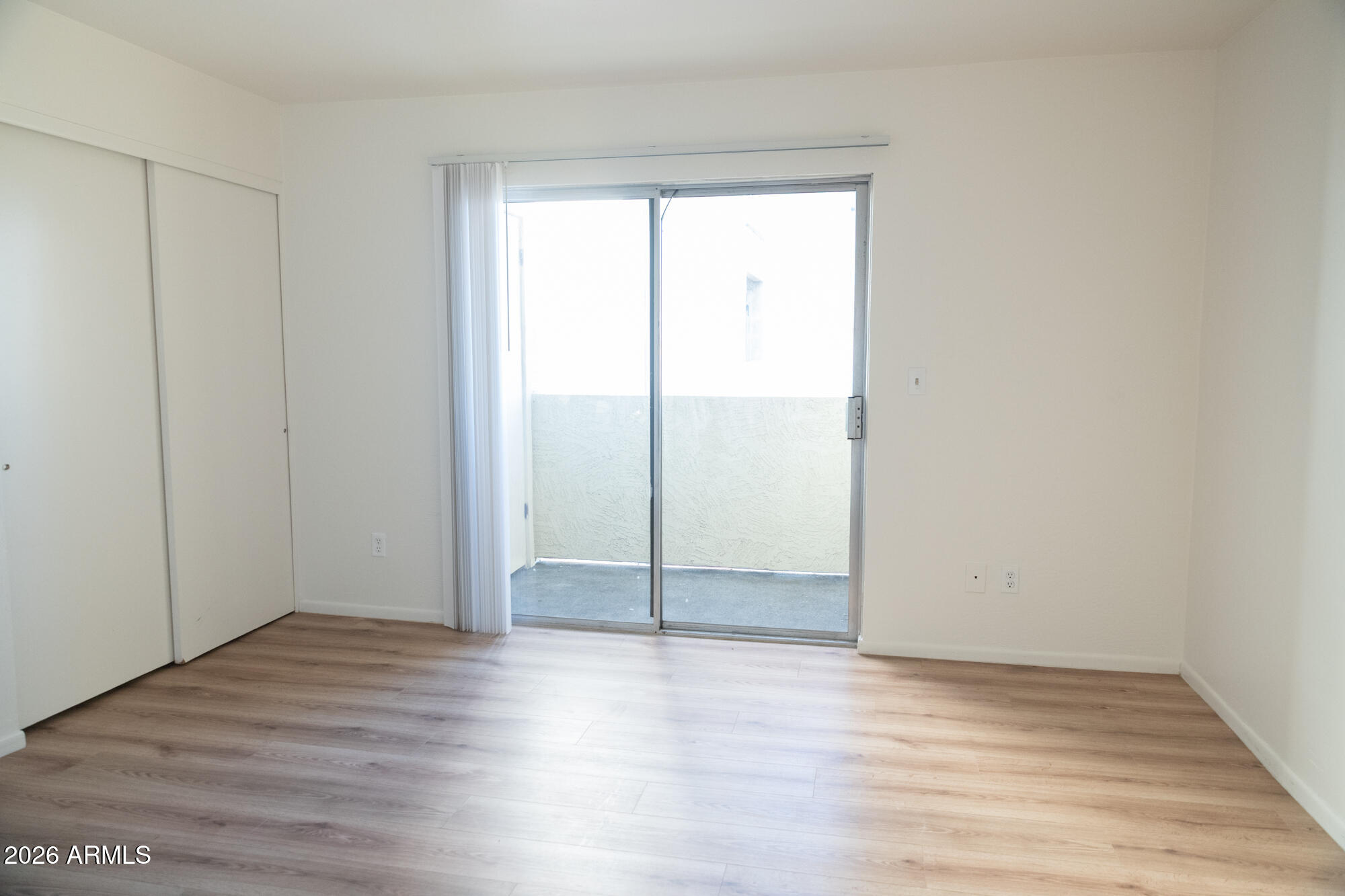 12123 West Bell Road, Unit 219 Surprise, AZ 85378 - Photo 13 of 23 a view of a room with wooden floor and window