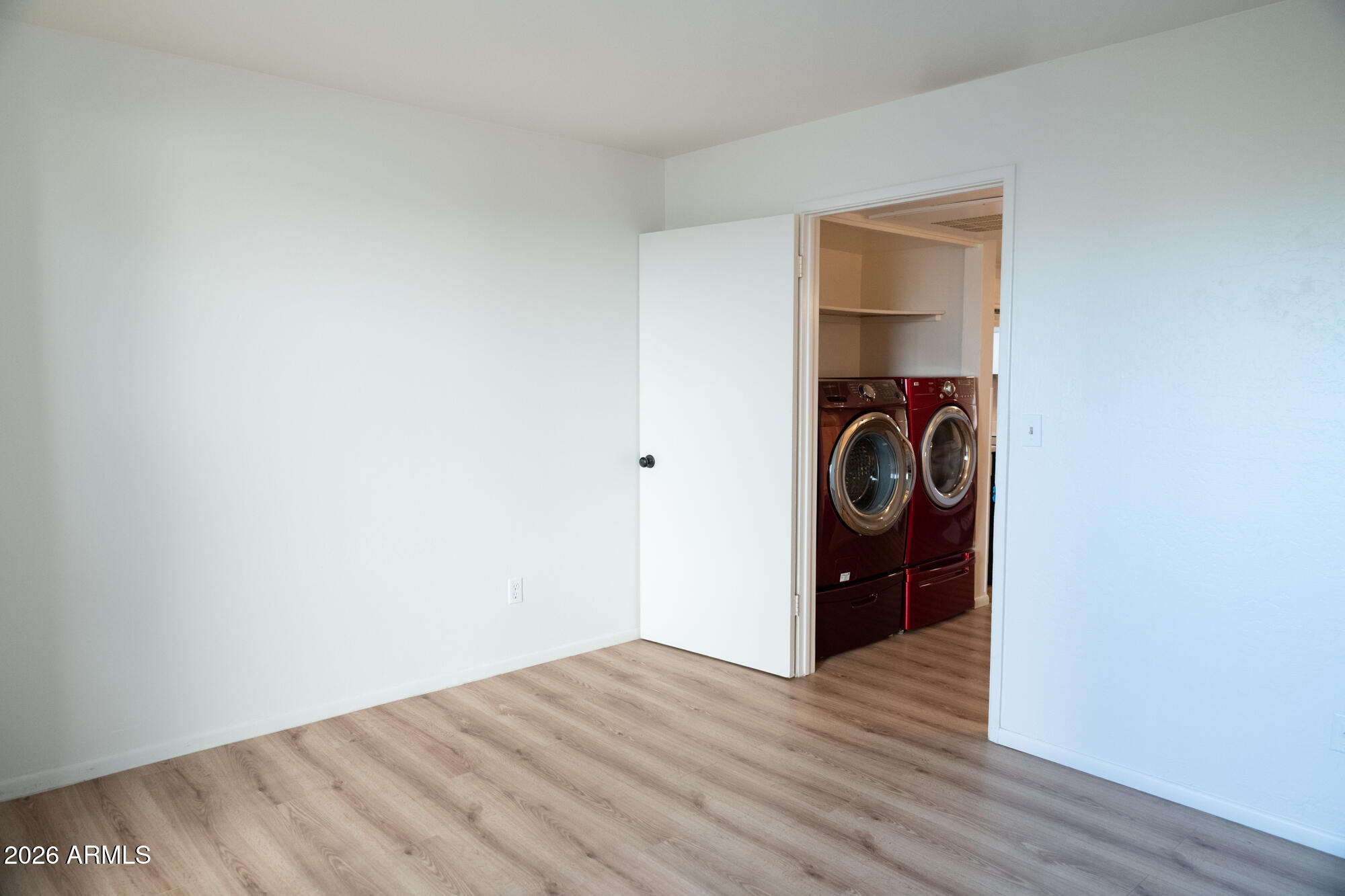 12123 West Bell Road, Unit 219 Surprise, AZ 85378 - Photo 15 of 23 a view of a storage & utility room with wooden floor