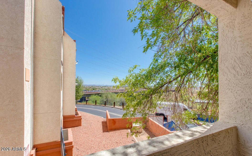 12123 West Bell Road, Unit 219 Surprise, AZ 85378 - Photo 16 of 23 view of balcony with two chairs and a table