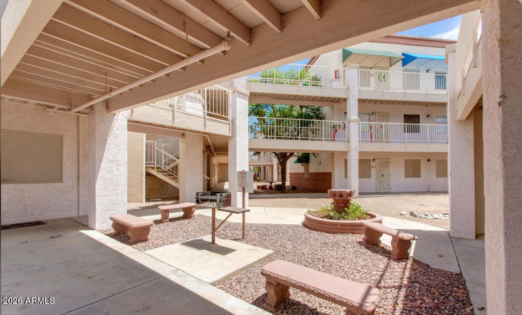 12123 West Bell Road, Unit 219 Surprise, AZ 85378 - Photo 20 of 23 a living room with furniture a fireplace and a table