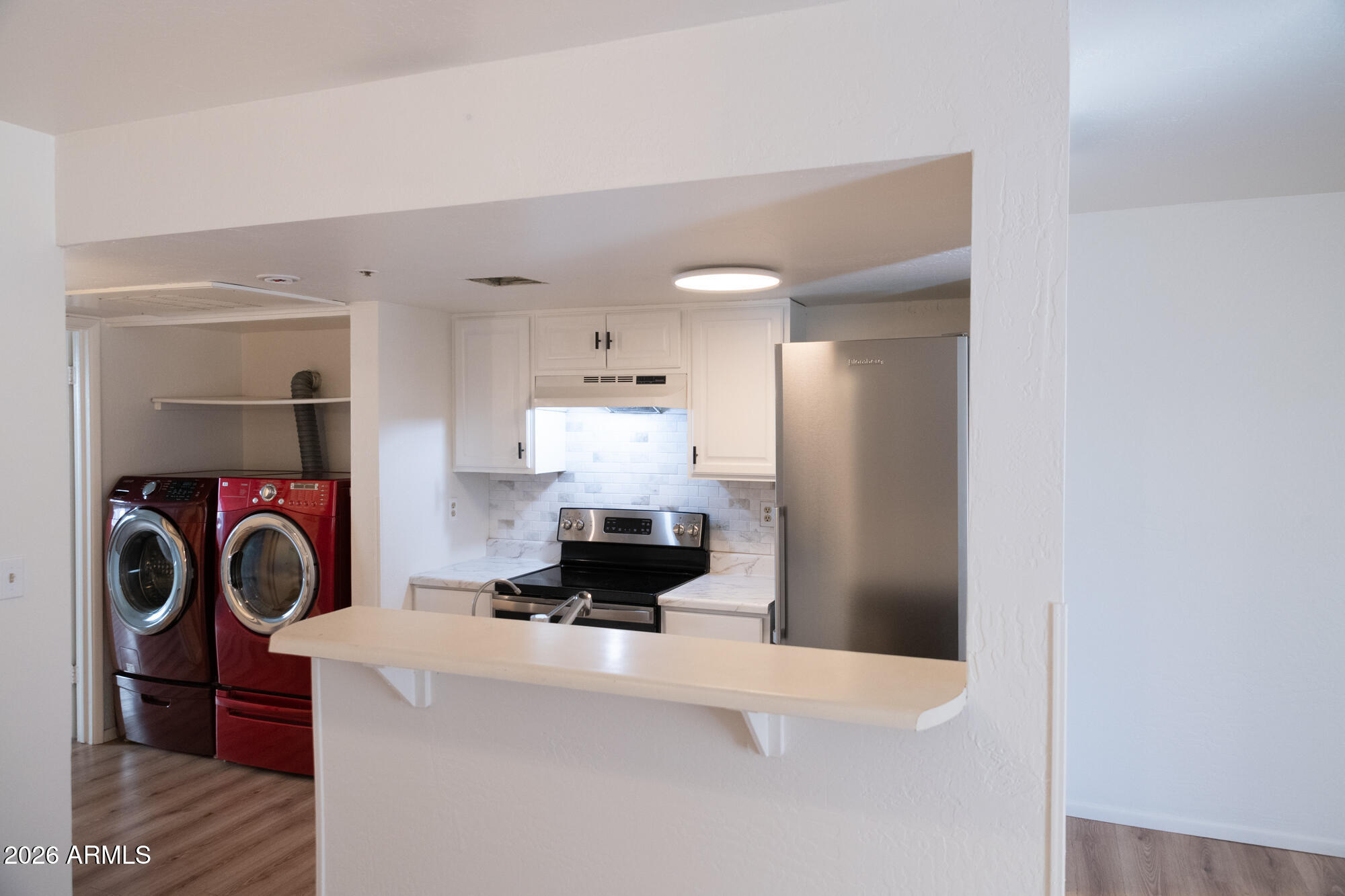12123 West Bell Road, Unit 219 Surprise, AZ 85378 - Photo 5 of 23 a view of kitchen and utility room