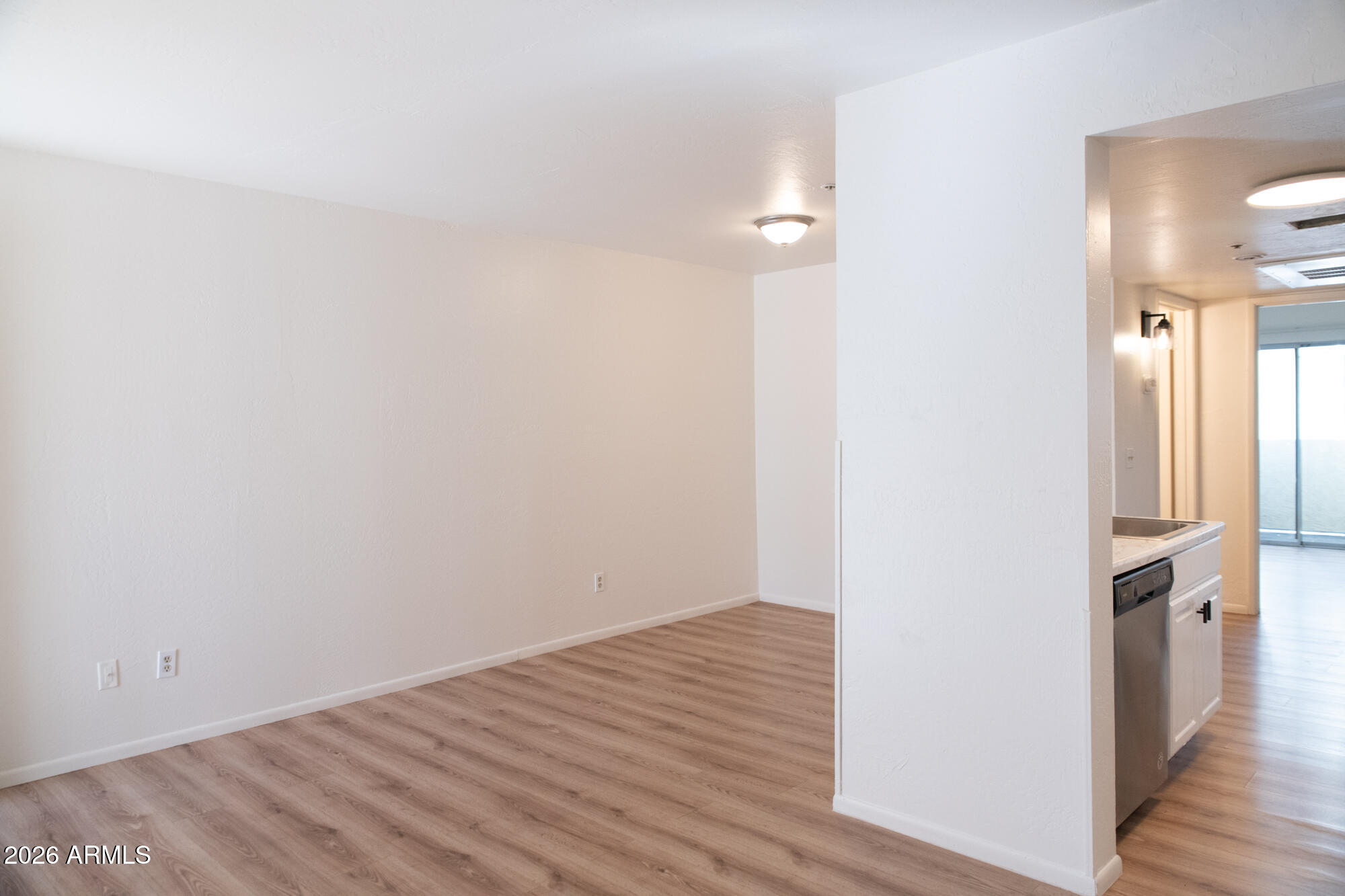 12123 West Bell Road, Unit 219 Surprise, AZ 85378 - Photo 9 of 23 a view of a room with wooden floor
