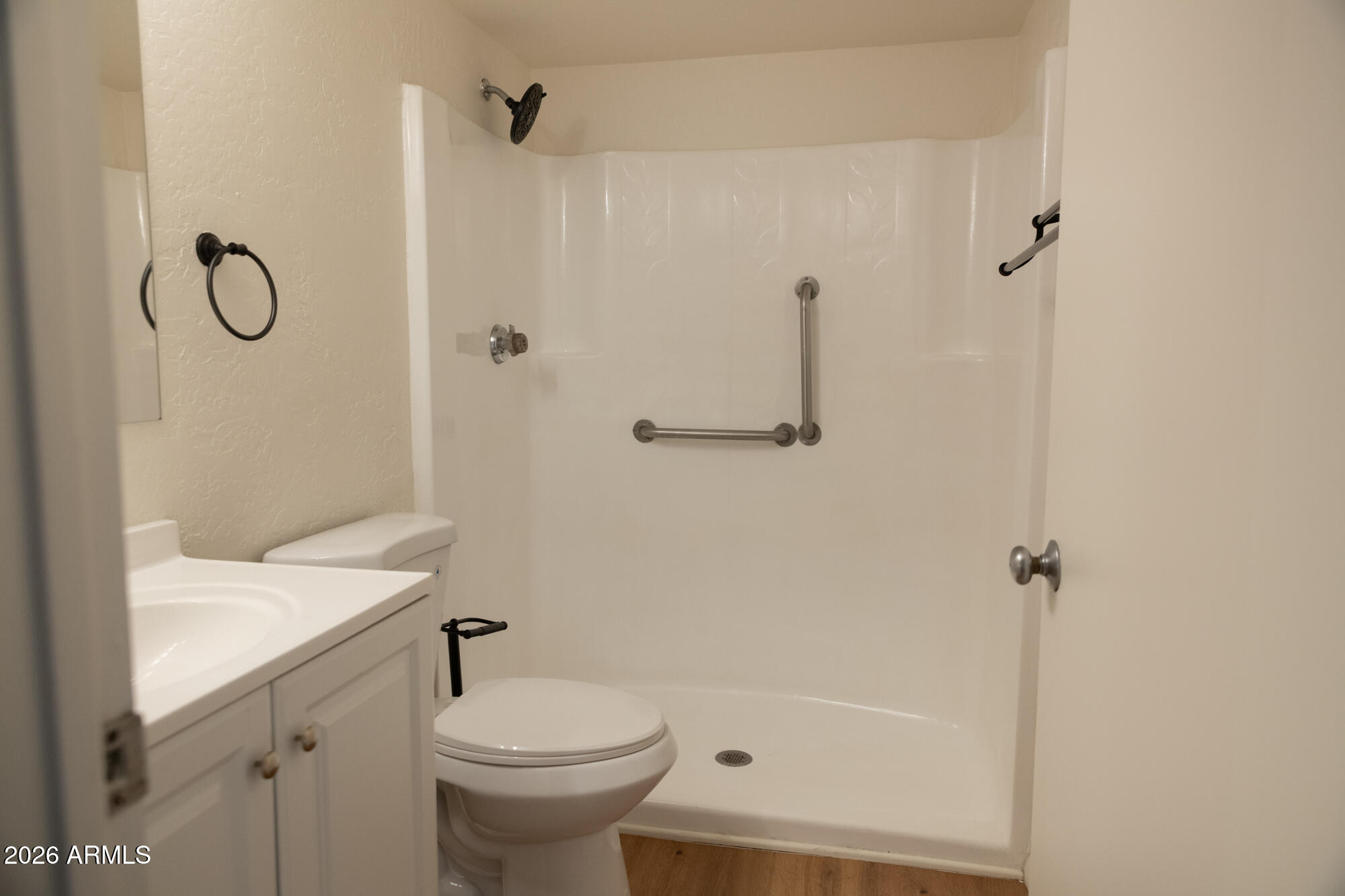 12123 West Bell Road, Unit 219 Surprise, AZ 85378 - Photo 10 of 23 a bathroom with a sink toilet and shower
