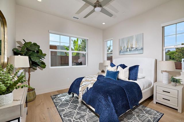 a bedroom with a large bed and a window