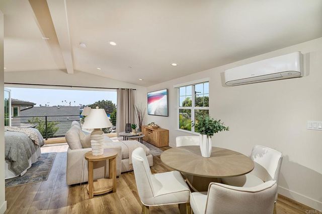 a dining room with furniture and wooden floor
