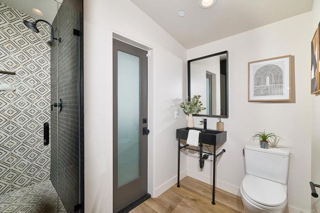a bathroom with a toilet a sink and mirror
