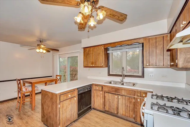a kitchen with stainless steel appliances granite countertop a sink and a stove