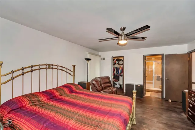 a bedroom with a bed and a ceiling fan