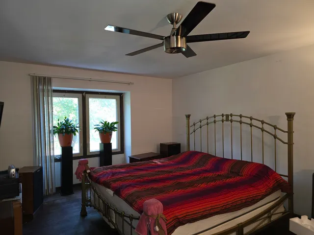 a bed sitting in a bedroom next to a window