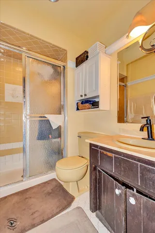 a bathroom with a sink a toilet and a shower