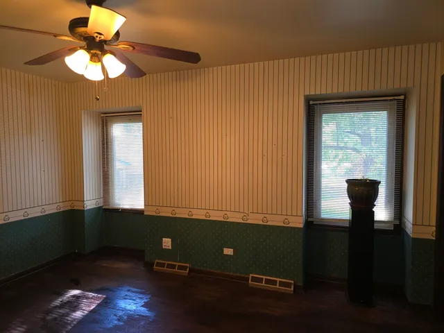 a view of room with window and wooden floor