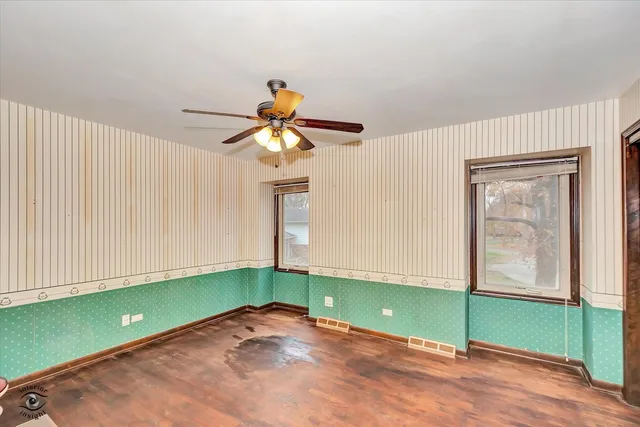 a view of a room with a fan and window