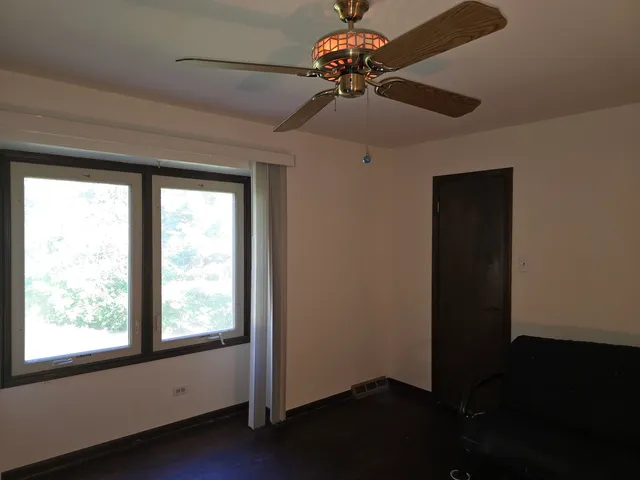 a view of a livingroom with a ceiling fan and a window