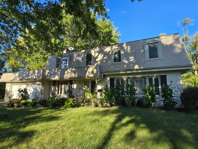 a front view of house and yard with green space