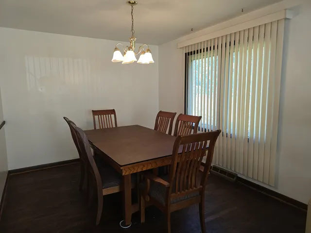 a view of a dining room with furniture wooden floor and chandelier