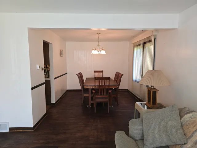 a dining room with furniture and wooden floor
