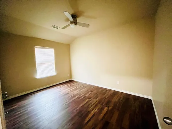 a view of an empty room and wooden floor