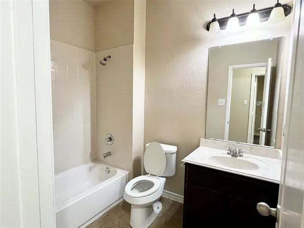 a bathroom with a sink a toilet and bathtub