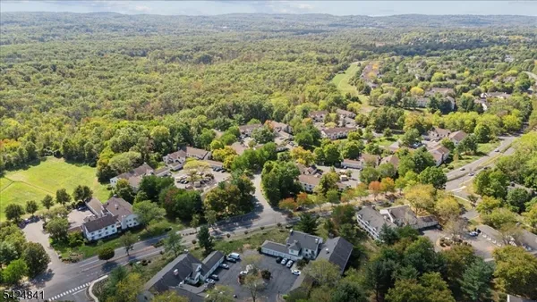 an aerial view of a houses with a yard