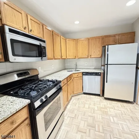 a kitchen with a stove a sink and a microwave