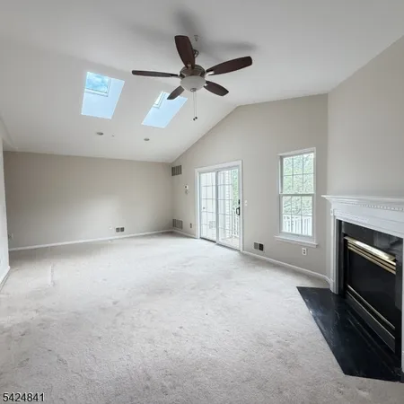 a view of an empty room with a fireplace