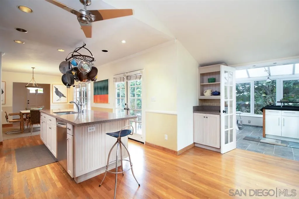 5004 Marlborough Drive San Diego, CA 92116 - Photo 13 of 25 a living room with kitchen island furniture and a wooden floor
