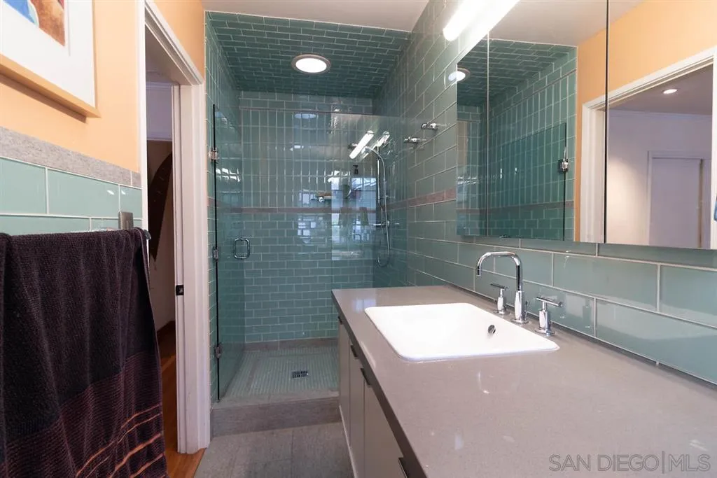 5004 Marlborough Drive San Diego, CA 92116 - Photo 20 of 25 a bathroom with a sink a toilet and shower