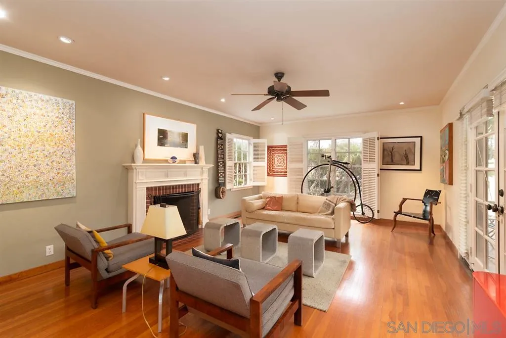 5004 Marlborough Drive San Diego, CA 92116 - Photo 7 of 25 a living room with fireplace furniture and a wooden floor