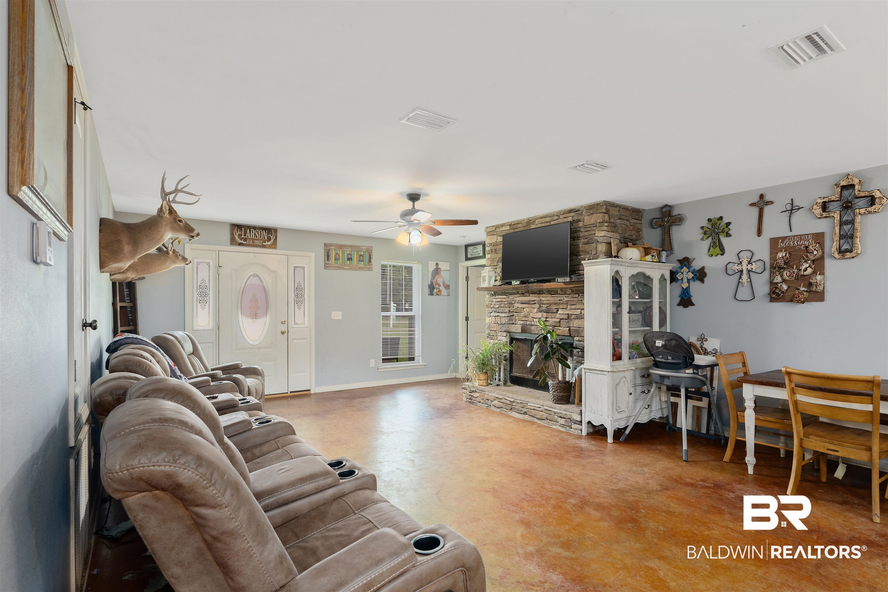 20076 Patty Jr Lane Bay Minette, AL 36507 - Photo 14 of 31 Living room with a fireplace, concrete flooring, and ceiling fan