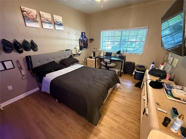 a bed room with two beds and a large window