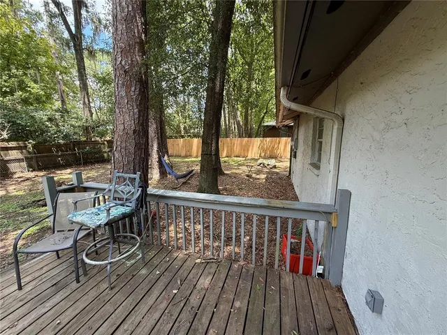 a view of balcony with wooden floor and outdoor seating
