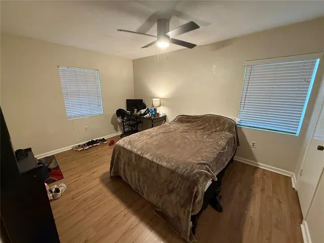 a bed sitting in a bedroom next to a window
