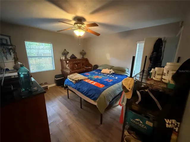 a living room with furniture a flat screen tv and a window