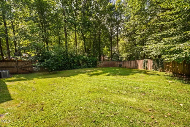 a view of a backyard with large trees