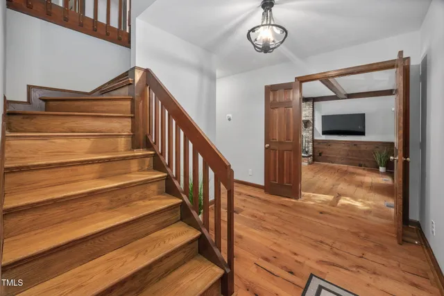 a view of entryway and hall with wooden floor