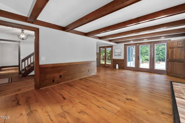 a view of a room with wooden floor and stairs