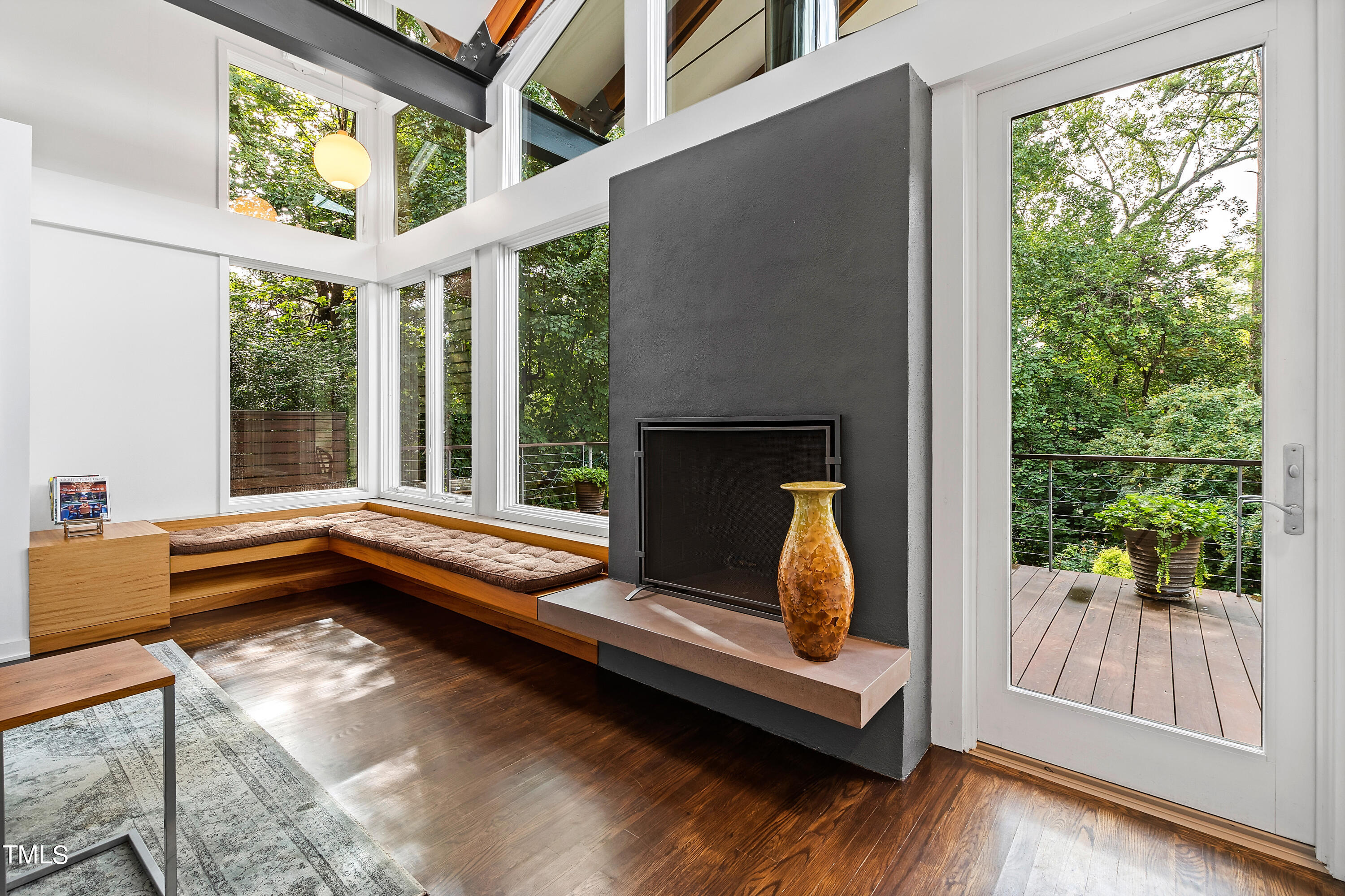 2212 The Circle Raleigh, NC 27608 - Photo 20 of 88 a living room with a fireplace furniture and a large window
