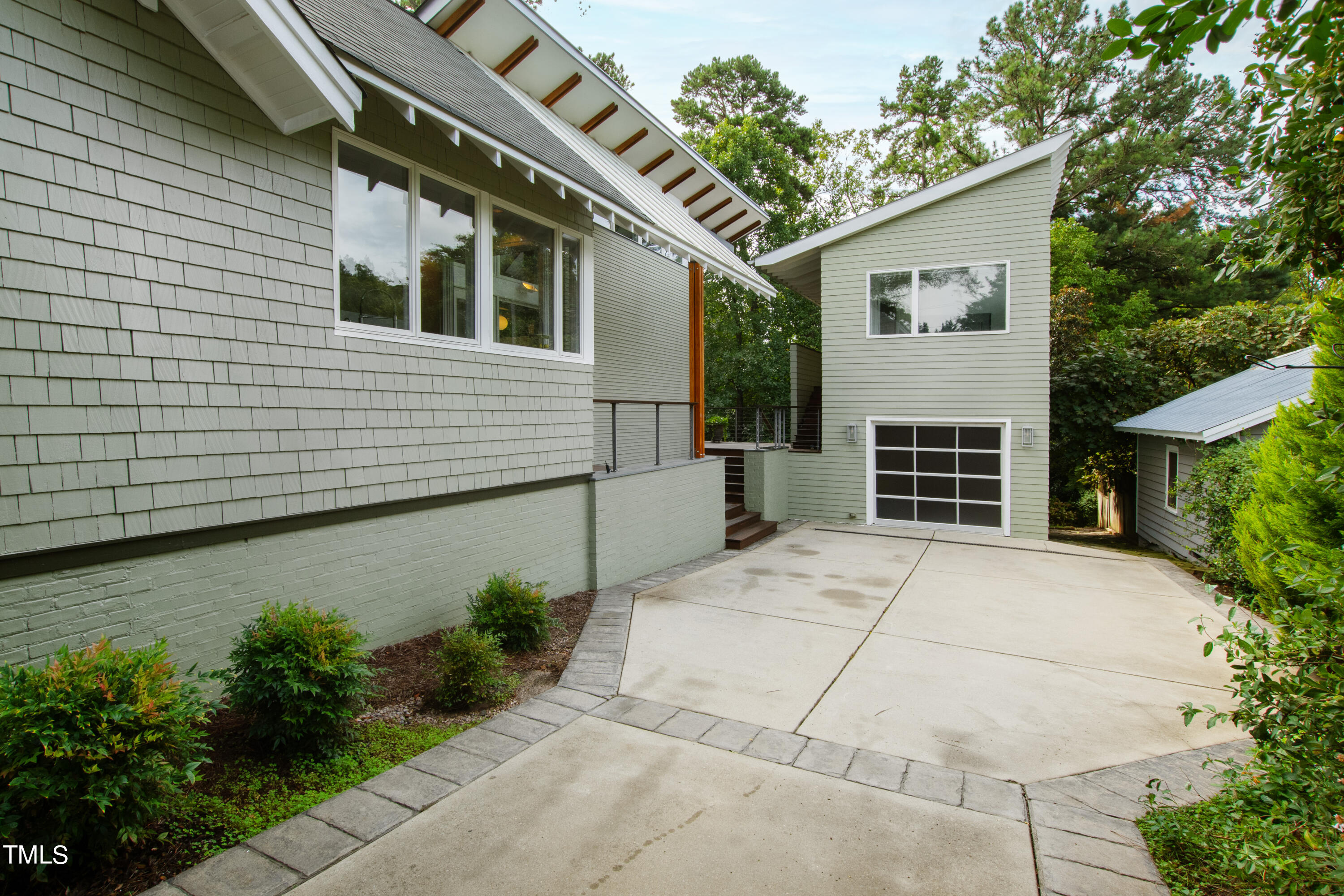 2212 The Circle Raleigh, NC 27608 - Photo 70 of 88 a backyard of a house with plants and trees